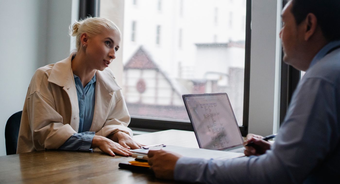 Business owner and consultant talking through a problem at a desk